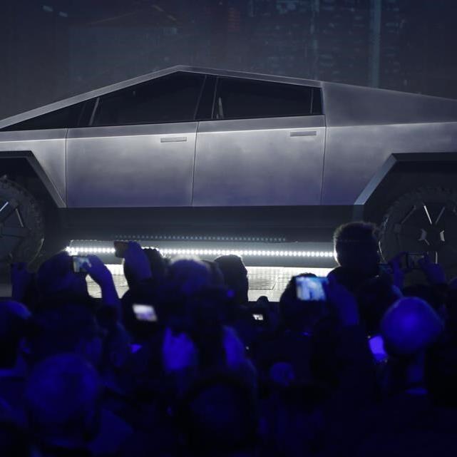 Tesla delivers about a dozen stainless steel Cybertruck pickups as it tries to fix production woes